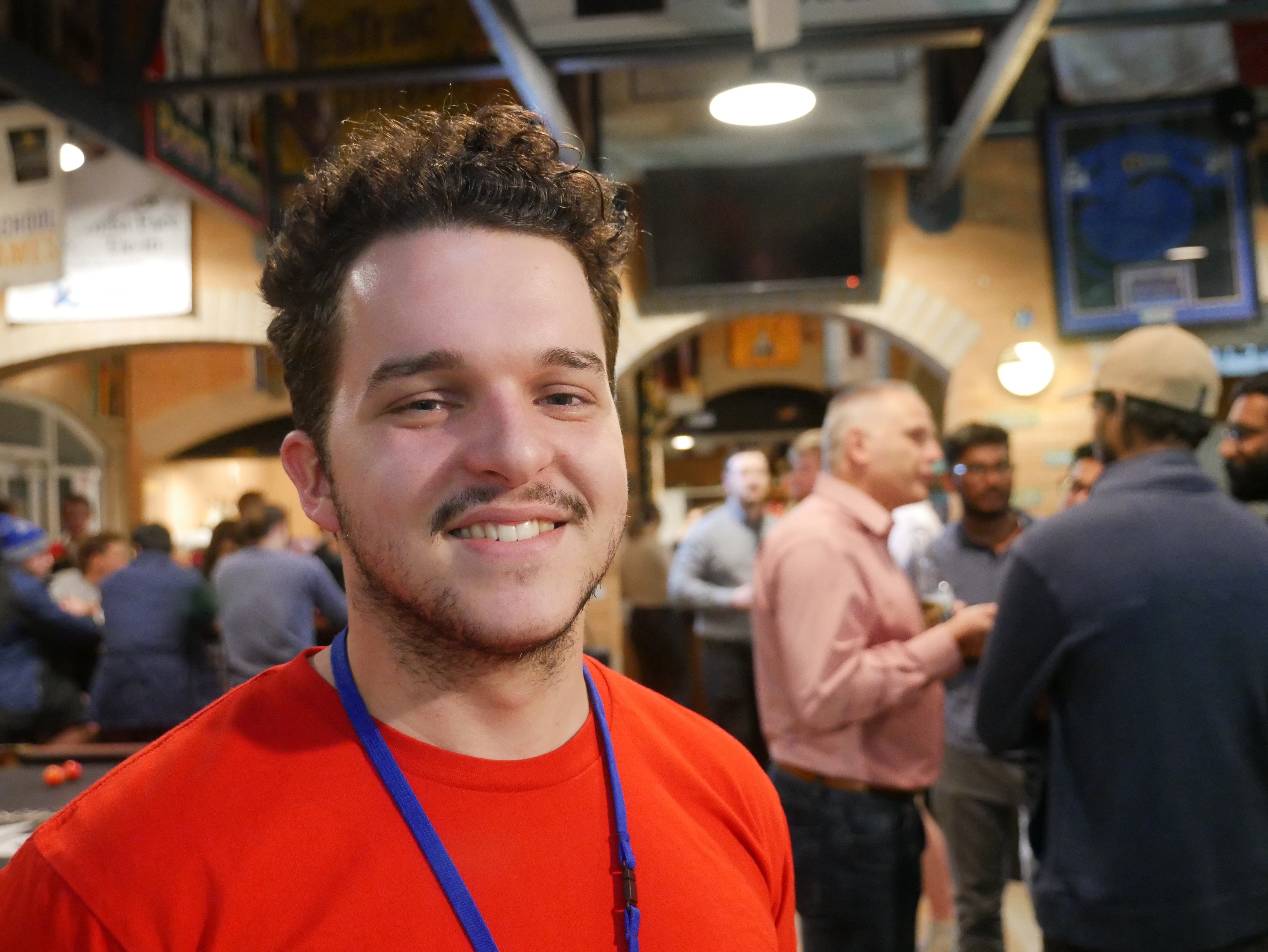 Young man smiling in a bar 