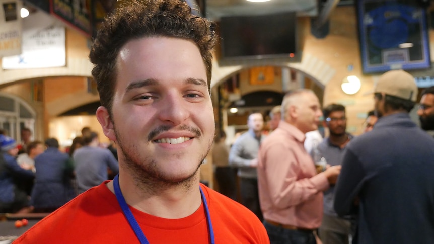 Young man smiling in a bar 