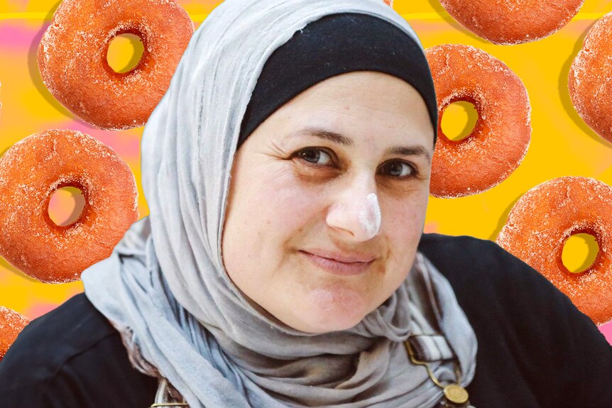 Frida Deguise smiling to the camera. Behind her are frosted donuts against a yellow and pink background.