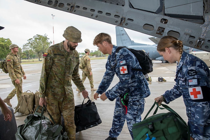 Members of the Australian Defence Force load their luggage into a plane ahead of rescue attempts in the Kimberley.