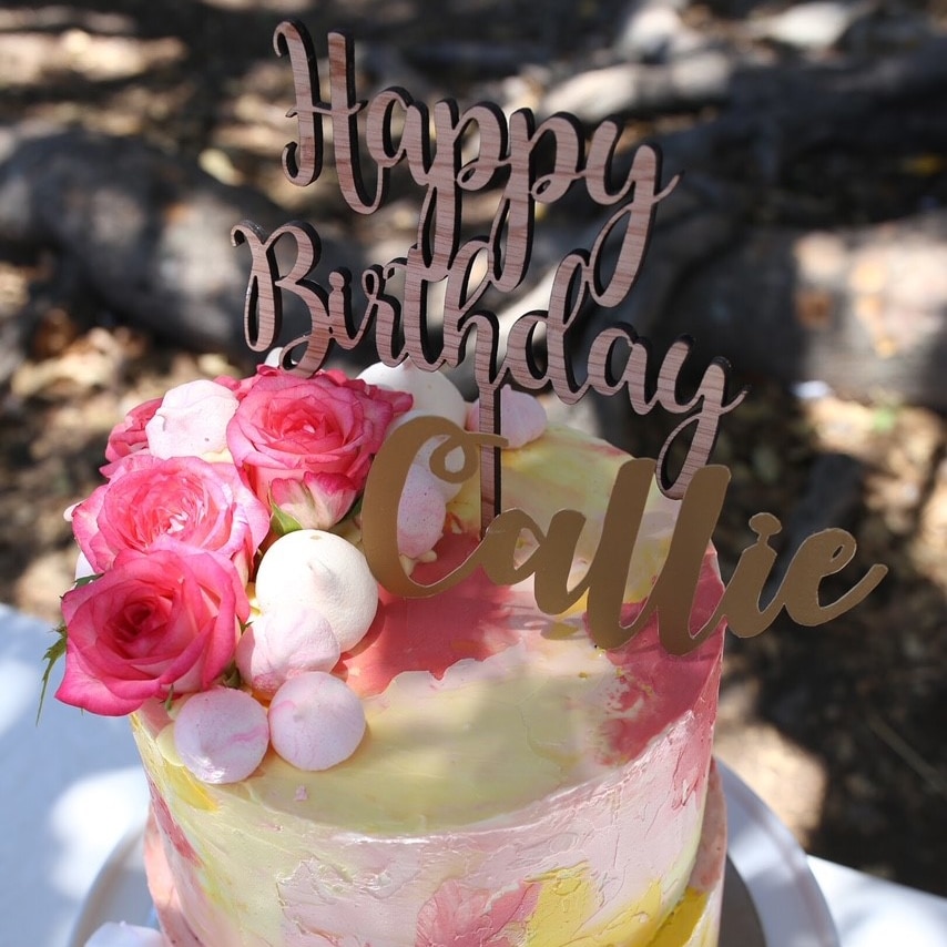 A cake with an elaborate name decoration