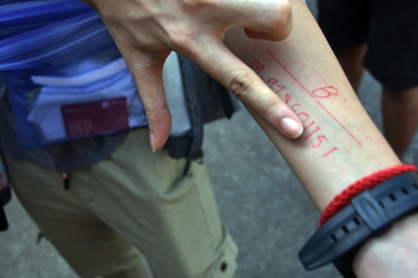 a close up shot of several numbers on someone's forearm