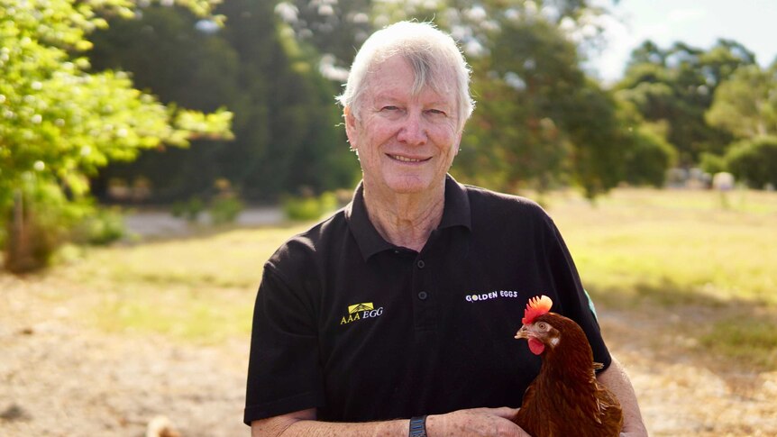 Golden Eggs managing director, Peter Bell holding one of his chickens