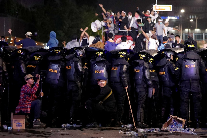 Riot police officers on guard during a riot near Indonesia's election supervisory agency.
