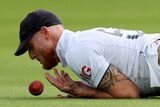 England fielder Ben Stokes drops the ball as he hits the ground.