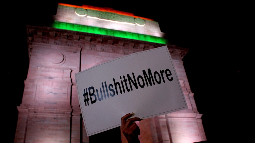 A hand hold ups a #BullshitNoMore sign.