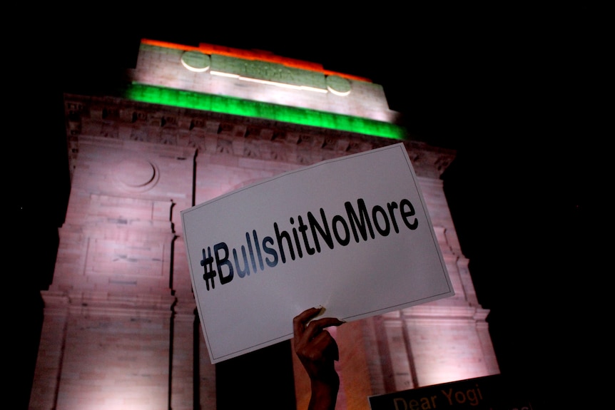 A hand hold ups a #BullshitNoMore sign.