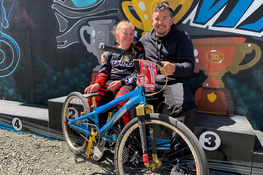 11 year old Chelsea Tuck sitting down with her Dad, Michael Tuck at the National BMX Championships in Launceston.