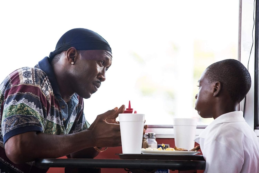 Mahershala Ali and Alex R Hibbert in a diner in a scene from Moonlight.