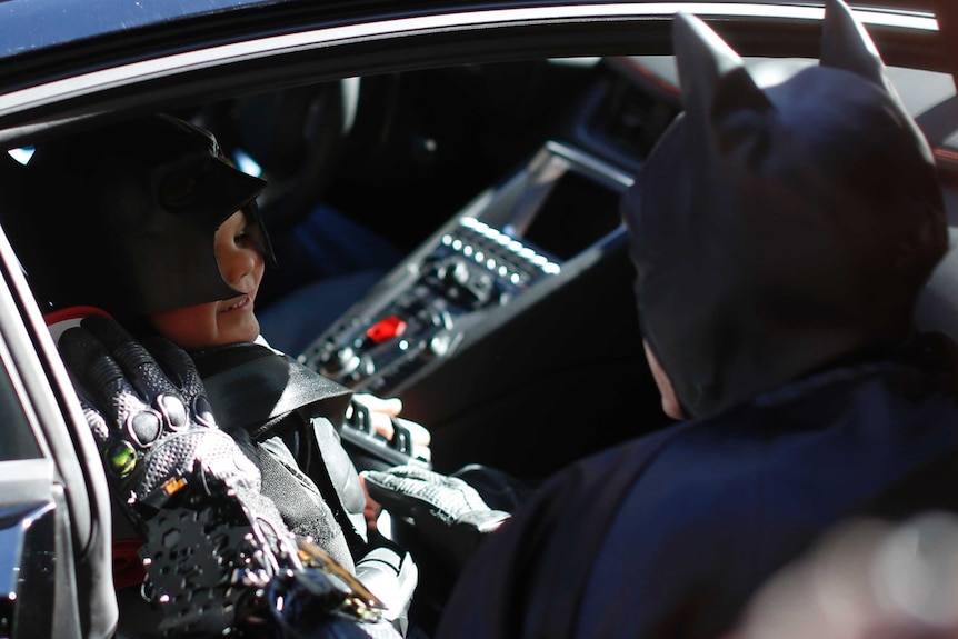 'Batkid' speaks to Batman from the Batmobile