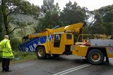 A crane was used to pull the truck back onto the road