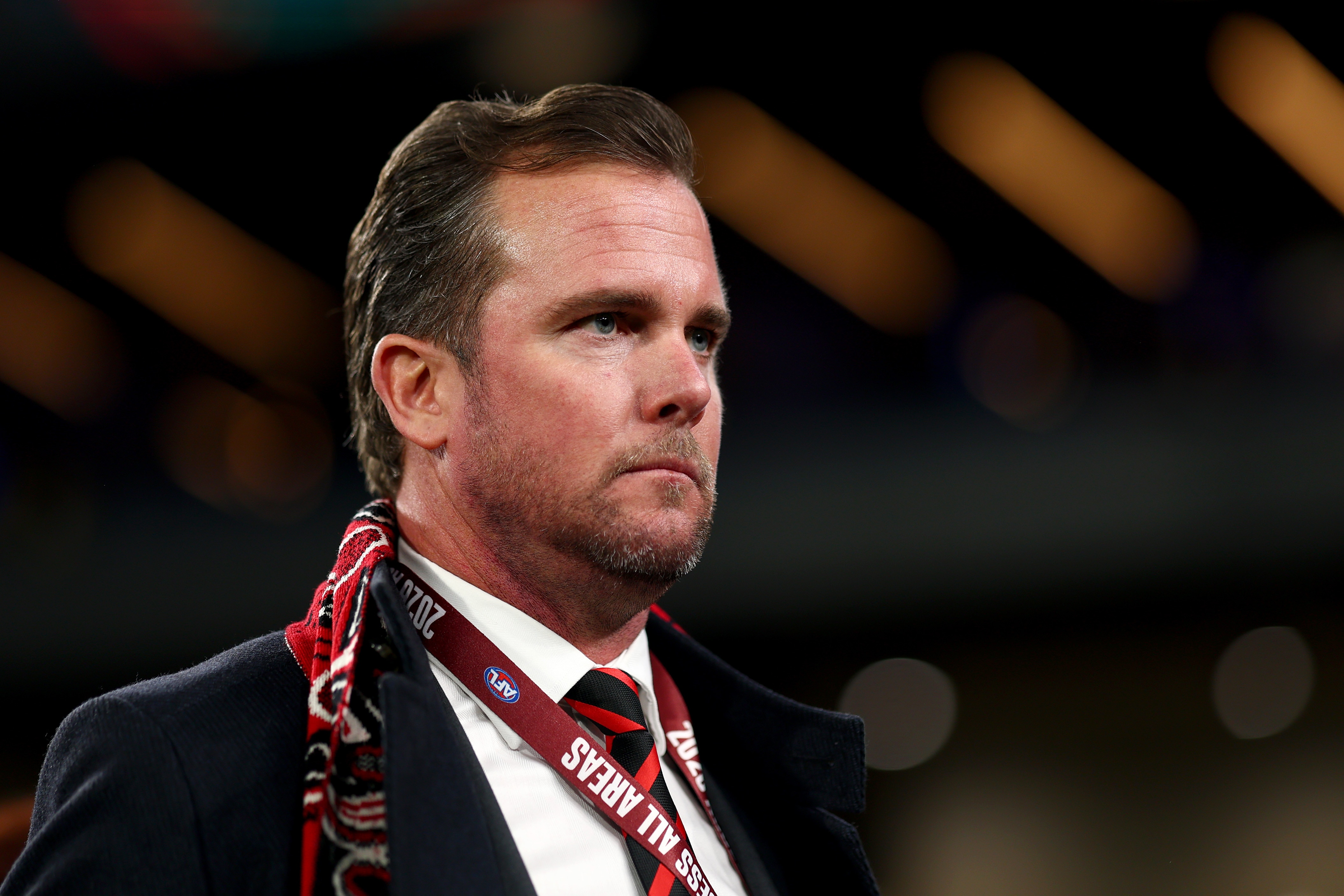 Andrew Welsh wearing Essendon scarf and lanyard