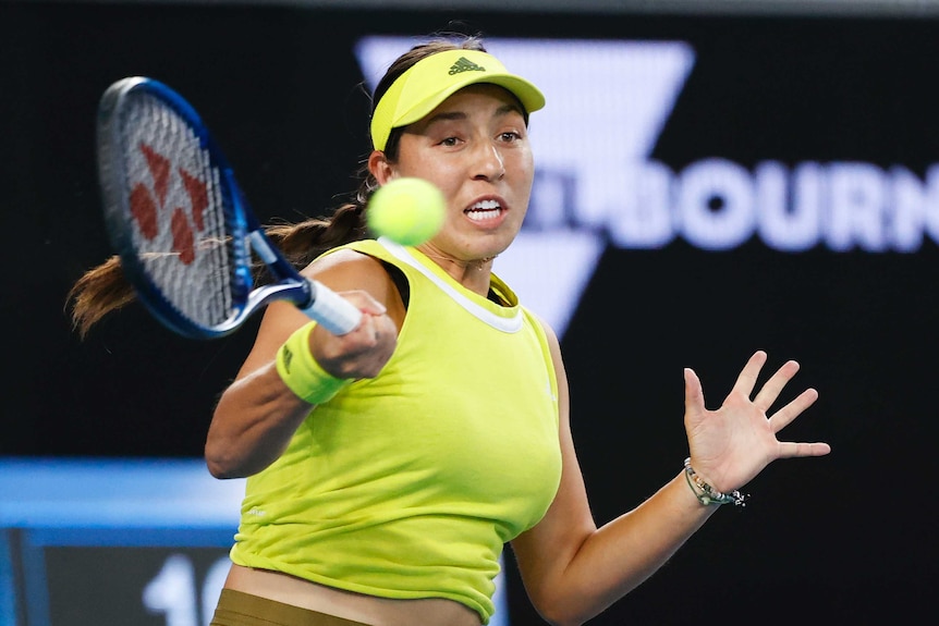 The muscles in a tennis player's arm clench as she hits a forehand during an Australian Open match.