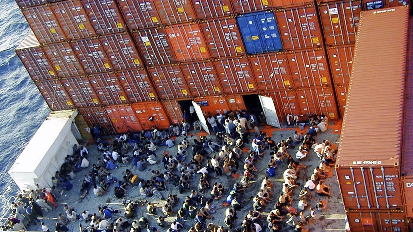 Some of the 438 asylum seekers onboard the Norwegian cargo ship MS Tampa anchored off Christmas Island on August 27, 2001