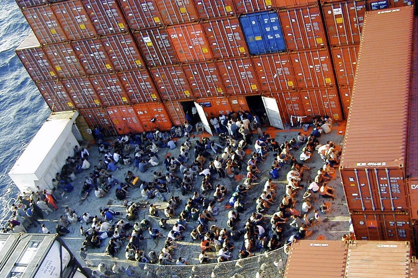 Some of the 438 asylum seekers onboard the Norwegian cargo ship MS Tampa anchored off Christmas Island on August 27, 2001
