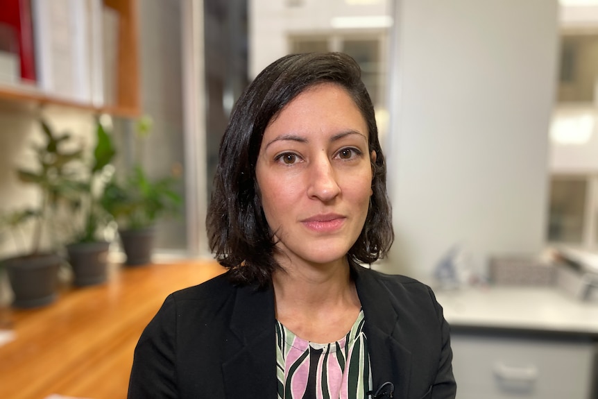 Stephanie Tonkin looks at the camera in an office.