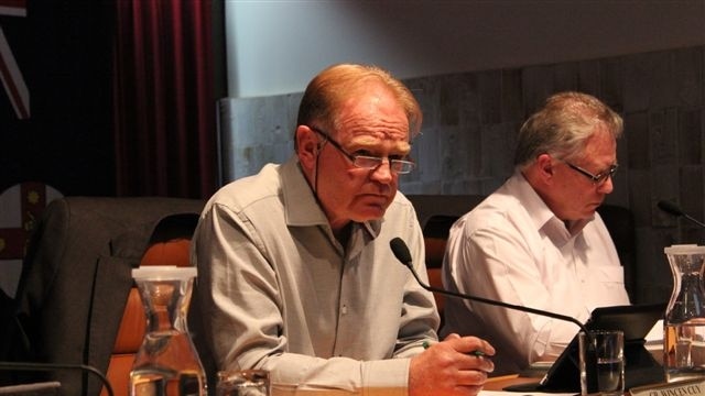 Broken Hill Mayor, Wincen Cuy, sits at a table during a council meeting