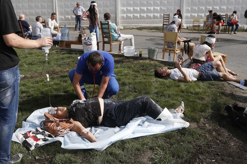 Paramedics treat passengers injured as several subway cars derailed in Moscow