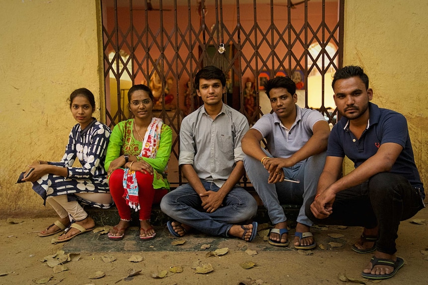 Five young members of the community who oppose virginity testing. They are sitting outside their community's temple.