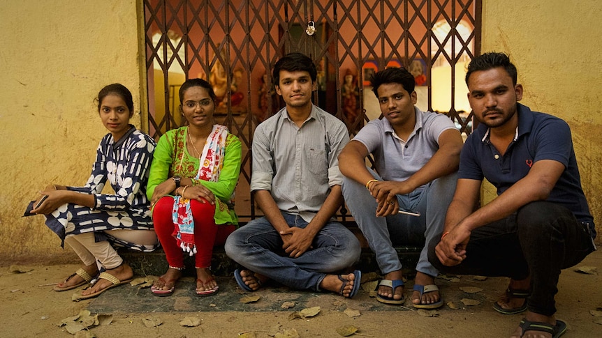 Five young members of the community who oppose virginity testing. They are sitting outside their community's temple.