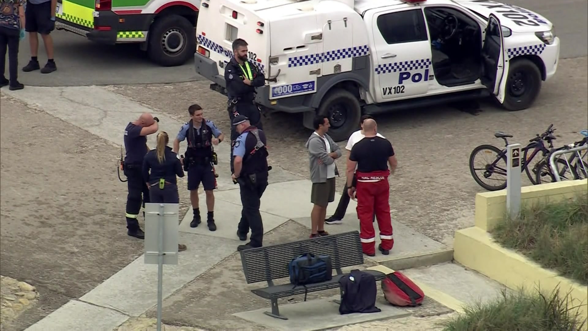 Emergency services gathered near their vehicles after a shark attack at Rottnest Island.