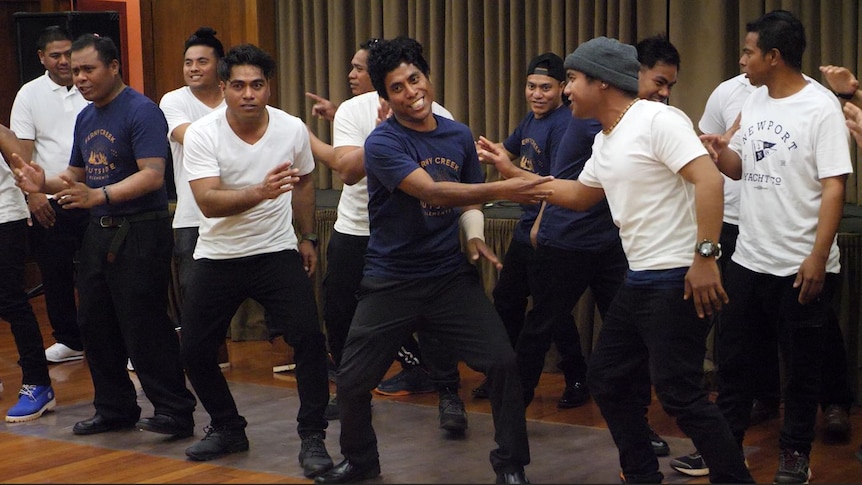 Seasonal workers from Kiribati perform in a hall in northern Tasmania