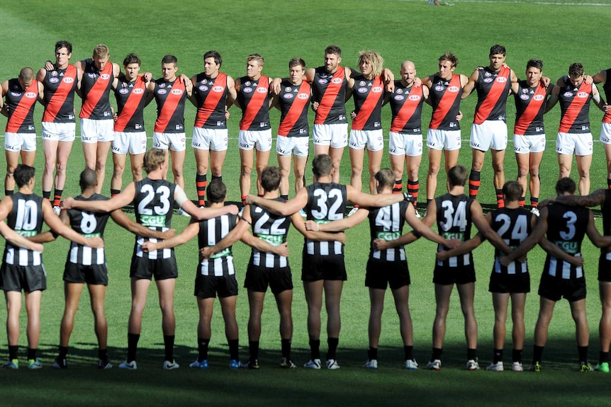 Collingwood and Essendon players face one another, pre-game, ahead of the ANZAC Day clash at the MCG.