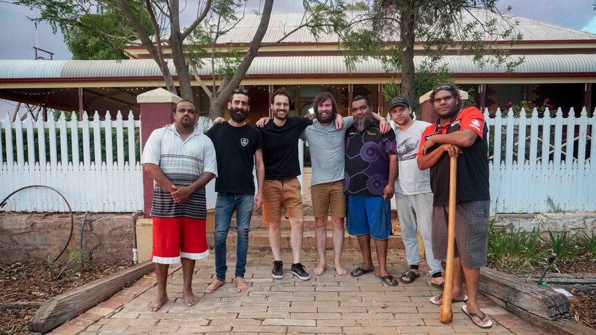 The recording team and local artist stand outside Hoover House.