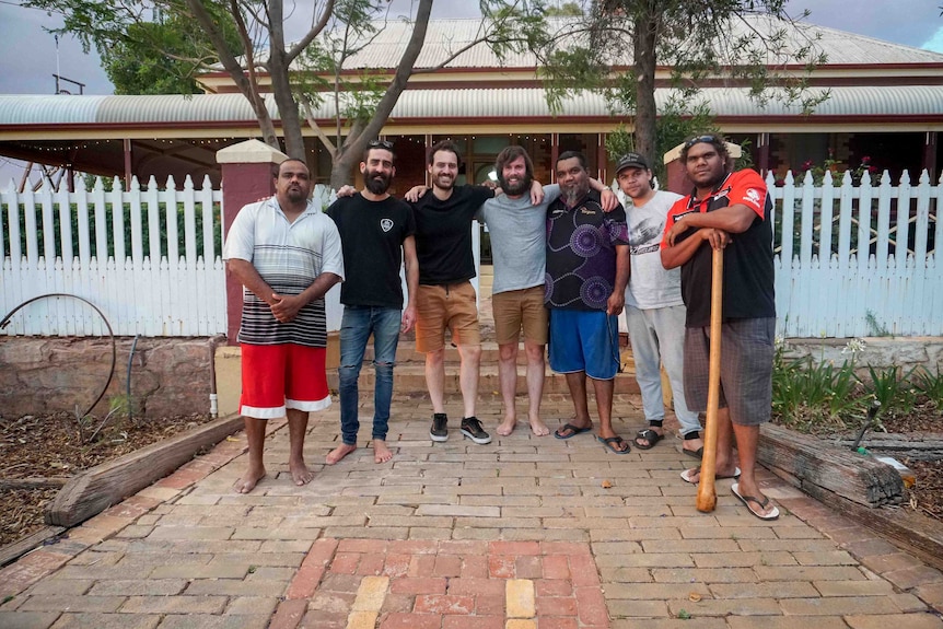 The recording team and local artist stand outside Hoover House.