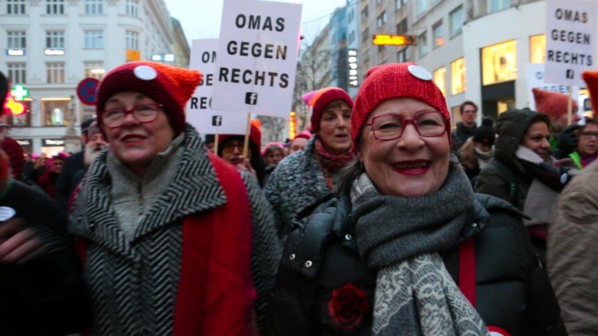 Susanne Scholl in scarf and beanie walks with other members of her group "Grandmothers Against the Right"
