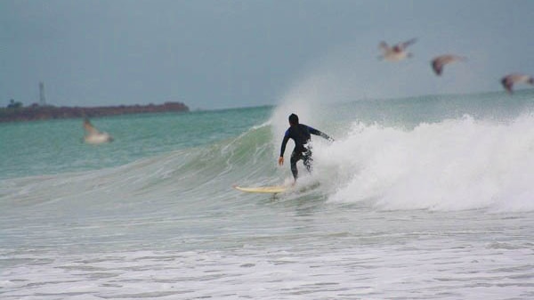 A surfer catches a rare wave at Cable Beach