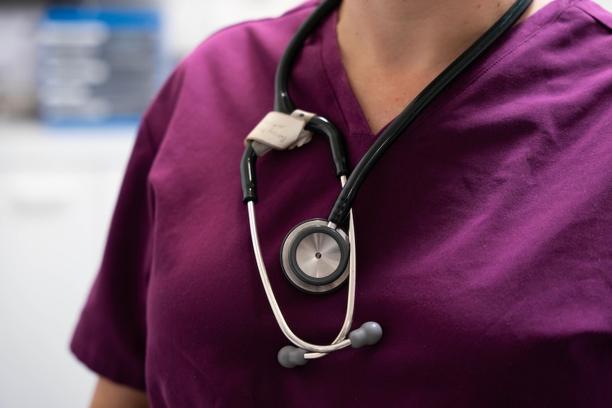 A female doctor carrying a stethoscope.