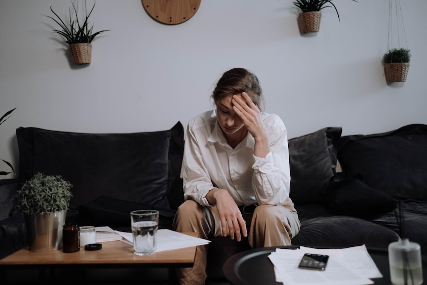 Woman stressed out with hand on forehead