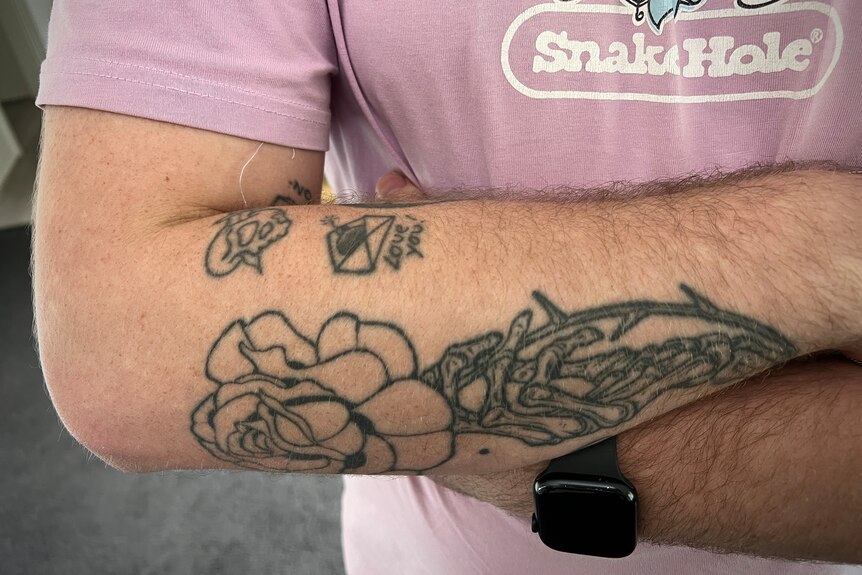 Aome small line tattoos on a man's arm