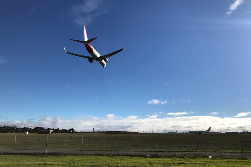 A plane lands at Melbourne Airport.