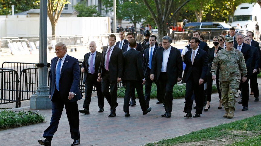 Former president Donald Trump walks in Lafayette Park to visit outside St John's Church
