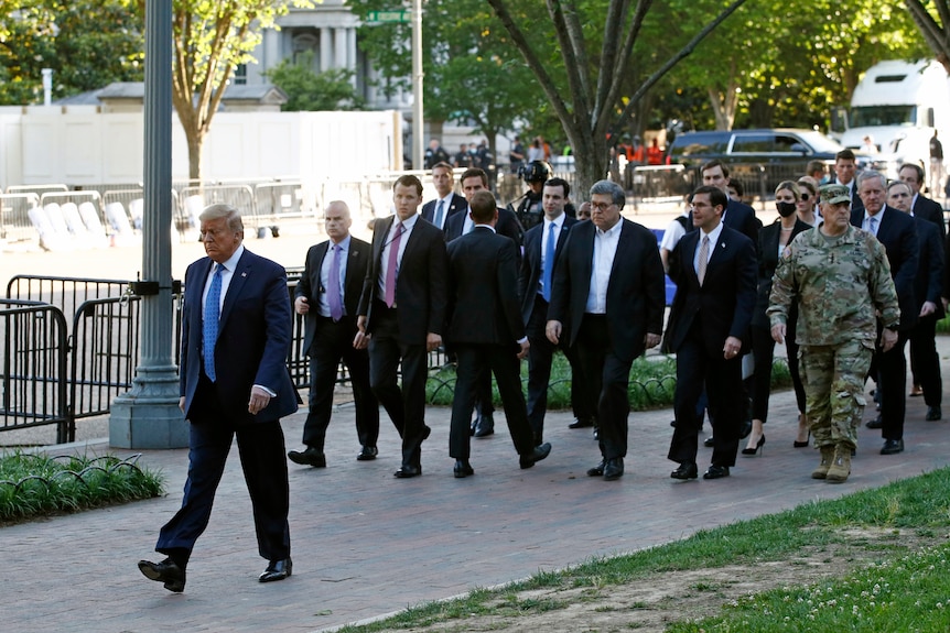Former president Donald Trump walks in Lafayette Park to visit outside St John's Church
