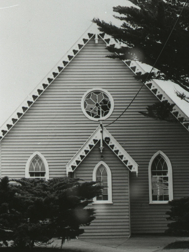 A beautiful church with pointed roof and stained glass windows.