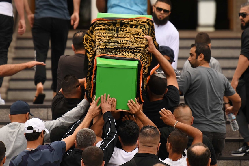 Coffin of boy carried out