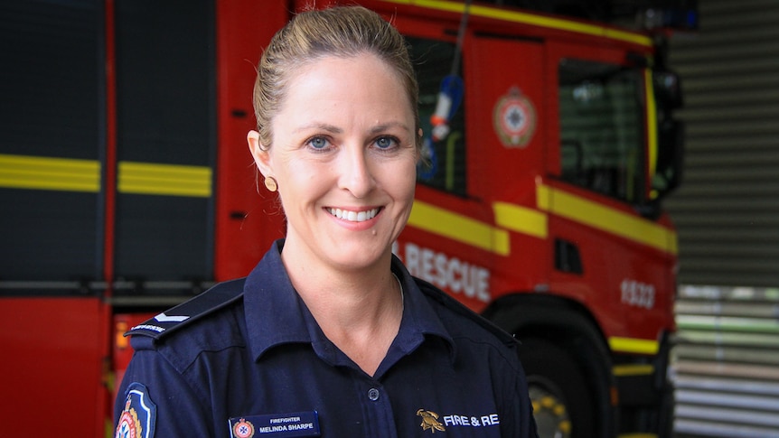Firefighter Melinda Sharpe at the Toowoomba fire station in front of a truck, March 2021.