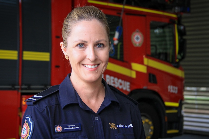 Firefighter Melinda Sharpe at the Toowoomba fire station in front of a truck, March 2021.