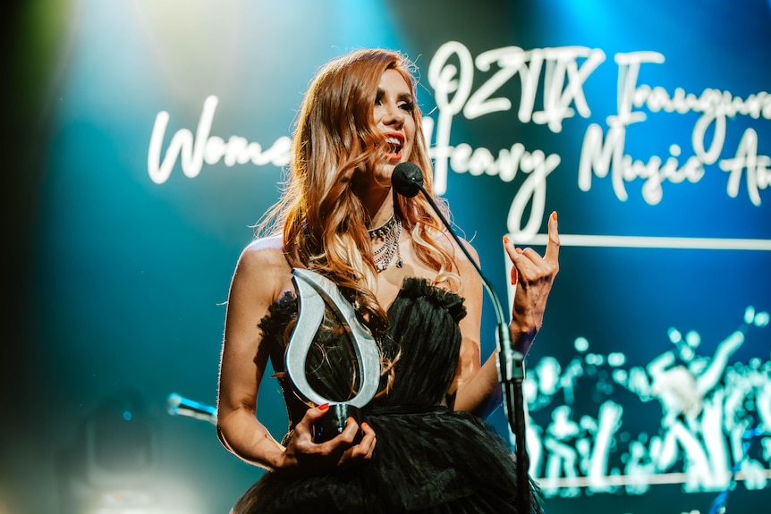 Horns up: Emmy Mack accepts the inaugural Women In Heavy Music Award