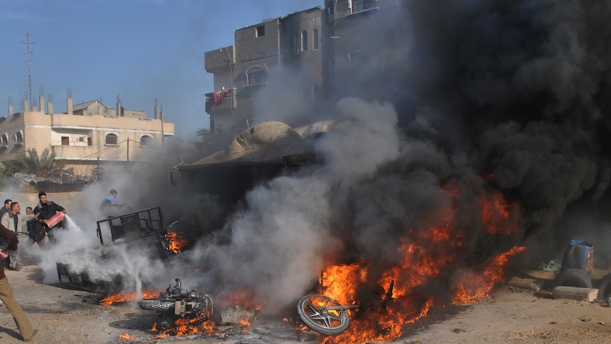 Palestinians try to extinguish Gaza fire