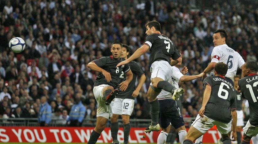 England's John Terry heads home his team's first goal