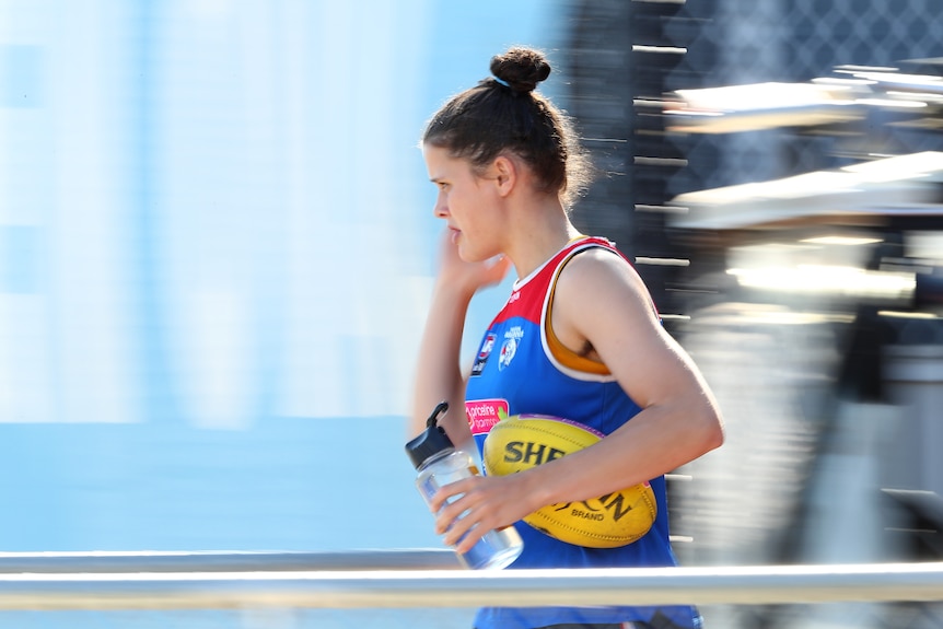 Nell Morris-Dalton arrives at training with a ball and water bottle