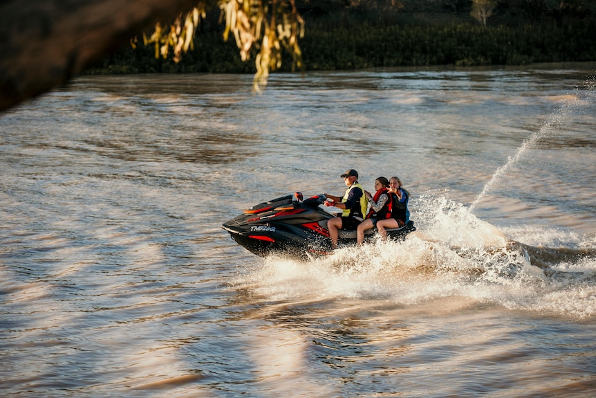 people riding a jetski in a river