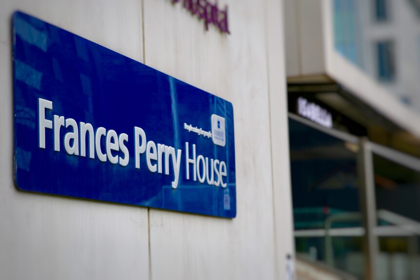 A sign of Frances Perry House private hospital in focus, with the building in the background.