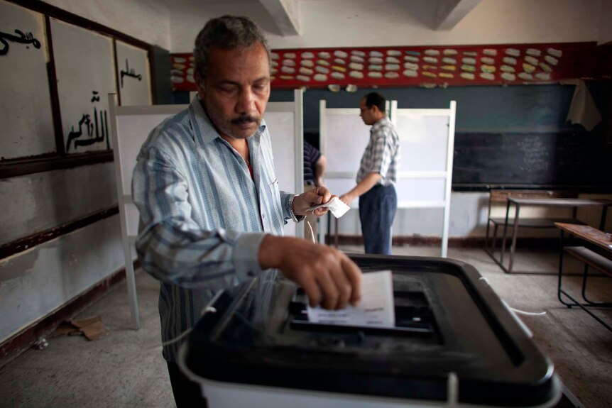 An Egyptian man casts his ballot