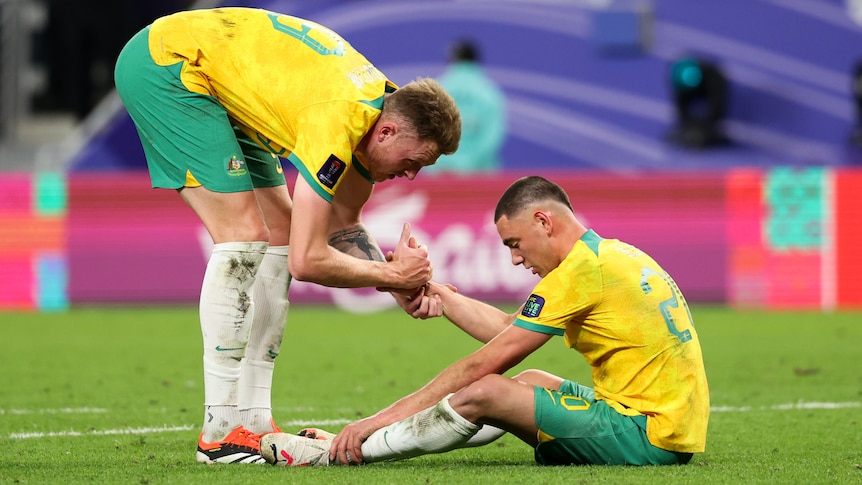 Harry Souttar consoles Lewis Miller after the Socceroos' Asian Cup loss to South Korea.