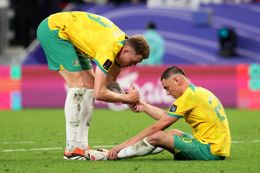 Harry Souttar consoles Lewis Miller after the Socceroos' Asian Cup loss to South Korea.